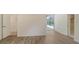 Bedroom featuring wood floors, neutral walls, and sliding glass doors leading to pool area at 8239 Cypress Hollow Dr, Sarasota, FL 34238
