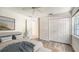 Bedroom showcasing wood floors, ceiling fan and a large closet at 8239 Cypress Hollow Dr, Sarasota, FL 34238