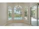 Breakfast nook features arched windows with views of the lanai and pool at 8239 Cypress Hollow Dr, Sarasota, FL 34238