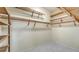 Walk-in closet with custom wood shelving and white marble floors at 8239 Cypress Hollow Dr, Sarasota, FL 34238