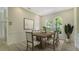 Classic dining room featuring wainscoting, arched windows, and a decorative area rug at 8239 Cypress Hollow Dr, Sarasota, FL 34238