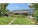 Back of property has screened-in lanai with pool and lush green landscaping at 8239 Cypress Hollow Dr, Sarasota, FL 34238