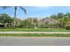 Beautiful single-story home with well-manicured lawn and tropical landscaping at 8239 Cypress Hollow Dr, Sarasota, FL 34238