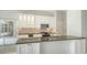 Bright kitchen features white cabinets, an island with breakfast bar, and stainless steel appliances at 8239 Cypress Hollow Dr, Sarasota, FL 34238