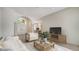 Bright living room with tile flooring and arched doorway and front entrance at 8239 Cypress Hollow Dr, Sarasota, FL 34238