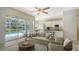 Sun-drenched living room features views of the lanai, pool, and an adjacent modern kitchen at 8239 Cypress Hollow Dr, Sarasota, FL 34238