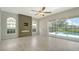 Spacious living room features a fireplace and sliding glass doors leading to the lanai and pool at 8239 Cypress Hollow Dr, Sarasota, FL 34238