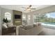 Bright living room boasts a modern fireplace, neutral furniture, and sliding glass doors to the pool area at 8239 Cypress Hollow Dr, Sarasota, FL 34238