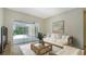Comfortable living room with sliding glass doors to screened in lanai at 8239 Cypress Hollow Dr, Sarasota, FL 34238