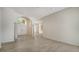 Spacious living area featuring tile flooring, arched doorway and front entrance at 8239 Cypress Hollow Dr, Sarasota, FL 34238