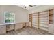 Bright office space with built-in shelving, a custom desk, and a large window offering a view of the outdoors at 8239 Cypress Hollow Dr, Sarasota, FL 34238