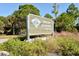 Welcome sign for Oscar Scherer State Park, nestled among lush Florida greenery at 8239 Cypress Hollow Dr, Sarasota, FL 34238