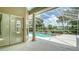 Covered pool and patio area featuring a swimming pool, spa, and view of the lake at 8239 Cypress Hollow Dr, Sarasota, FL 34238