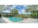 Enjoy this pool and spa in a screened-in lanai, perfect for entertaining friends and Gathering at 8239 Cypress Hollow Dr, Sarasota, FL 34238