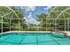 Relaxing screened-in pool and spa overlooking the lush landscaping and lake view at 8239 Cypress Hollow Dr, Sarasota, FL 34238