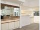 Home bar with mirrored shelving, sink and lots of storage at 8260 Berkeley Manor Blvd, Spring Hill, FL 34606