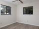 Bedroom with updated flooring and two windows offering natural light at 8260 Berkeley Manor Blvd, Spring Hill, FL 34606