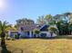 Single-story home with attached garage and mature landscaping on a sunny day at 8260 Berkeley Manor Blvd, Spring Hill, FL 34606