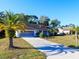 Well maintained house with an attached garage and palm trees in a sunny location at 8260 Berkeley Manor Blvd, Spring Hill, FL 34606
