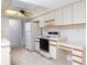 Classic white kitchen with ample cabinet storage, and bright recessed ceiling light at 8260 Berkeley Manor Blvd, Spring Hill, FL 34606