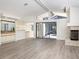 Bright living room with vaulted ceilings, fireplace, bar, and sliding glass doors to the pool at 8260 Berkeley Manor Blvd, Spring Hill, FL 34606