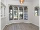 Light-filled living room featuring a bay window with views of the landscaped front yard at 8260 Berkeley Manor Blvd, Spring Hill, FL 34606