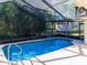 Screened-in pool, an inviting oasis for relaxation and entertainment at 8260 Berkeley Manor Blvd, Spring Hill, FL 34606