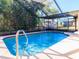 Inviting screened-in pool offers a private outdoor oasis for recreation at 8260 Berkeley Manor Blvd, Spring Hill, FL 34606