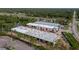 Aerial view of new construction with multiple buildings near residential neighborhood and wetlands at 829 57Th E St, Bradenton, FL 34208