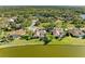 Scenic aerial shot of homes with screened-in pools backing onto a tranquil lake in a wooded area at 8315 Eagle Xing, Sarasota, FL 34241