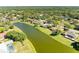 Stunning aerial shot of the home nestled along a waterway, surrounded by lush landscaping at 8315 Eagle Xing, Sarasota, FL 34241