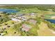 Stunning aerial view of the community featuring tennis courts, a golf course, and a clubhouse with ample parking at 8315 Eagle Xing, Sarasota, FL 34241