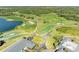 Beautiful aerial shot of the golf course featuring well-manicured greens, sand traps, and a community clubhouse at 8315 Eagle Xing, Sarasota, FL 34241