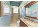 Bathroom featuring a glass block window in the tiled walk in shower, granite countertop, and wood cabinets at 8315 Eagle Xing, Sarasota, FL 34241