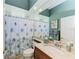 Bathroom featuring a vanity with marble countertop, large mirror, and a shower with a patterned curtain at 8315 Eagle Xing, Sarasota, FL 34241