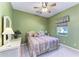 Cozy bedroom with a wicker dresser, bedside table, and bright window at 8315 Eagle Xing, Sarasota, FL 34241