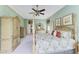Spacious bedroom with a four-poster bed, ceiling fan, and large wardrobe at 8315 Eagle Xing, Sarasota, FL 34241