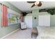 Bright bedroom with a view of the lake, a chair, and a king sized bed at 8315 Eagle Xing, Sarasota, FL 34241
