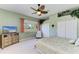 Bedroom with carpeted floors, a large dresser with TV, and a view of the water at 8315 Eagle Xing, Sarasota, FL 34241
