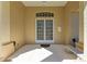 Close-up of the home's front door featuring double doors, an arched window, and a tiled entryway at 8315 Eagle Xing, Sarasota, FL 34241