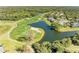 Scenic aerial view of the golf course showcasing lush greens, sand traps, and a serene lake at 8315 Eagle Xing, Sarasota, FL 34241