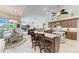 Bright and open kitchen featuring granite counters, a spacious island, custom wood cabinets and adjacent dining area at 8315 Eagle Xing, Sarasota, FL 34241