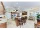 Open kitchen with granite counters, wood cabinetry, island seating, and a breakfast nook in a bright, spacious layout at 8315 Eagle Xing, Sarasota, FL 34241