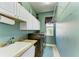 Laundry room with modern front loading washer and dryer, a utility sink, and a window at 8315 Eagle Xing, Sarasota, FL 34241