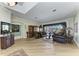 Elegant living room featuring hardwood floors, crown molding, and views of the pool through a large window at 8315 Eagle Xing, Sarasota, FL 34241