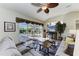 Inviting living room with sliders to the lanai, a ceiling fan, and cozy seating at 8315 Eagle Xing, Sarasota, FL 34241