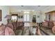 Formal living room featuring hardwood floors, elegant decor, and an arched entryway to other areas of the house at 8315 Eagle Xing, Sarasota, FL 34241