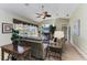 Cozy living room with comfortable seating, ceiling fan, and a view of the lanai and pool at 8315 Eagle Xing, Sarasota, FL 34241