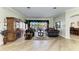 Inviting living room with hardwood floors, elegant decor, and a large window overlooking the outdoor space at 8315 Eagle Xing, Sarasota, FL 34241