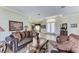 Stylish living room showcasing hardwood floors, elegant furnishings, and a clear view of the front entrance at 8315 Eagle Xing, Sarasota, FL 34241